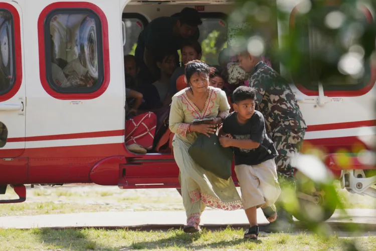Rescuers retrieve Nepal flood survivors caked in mud